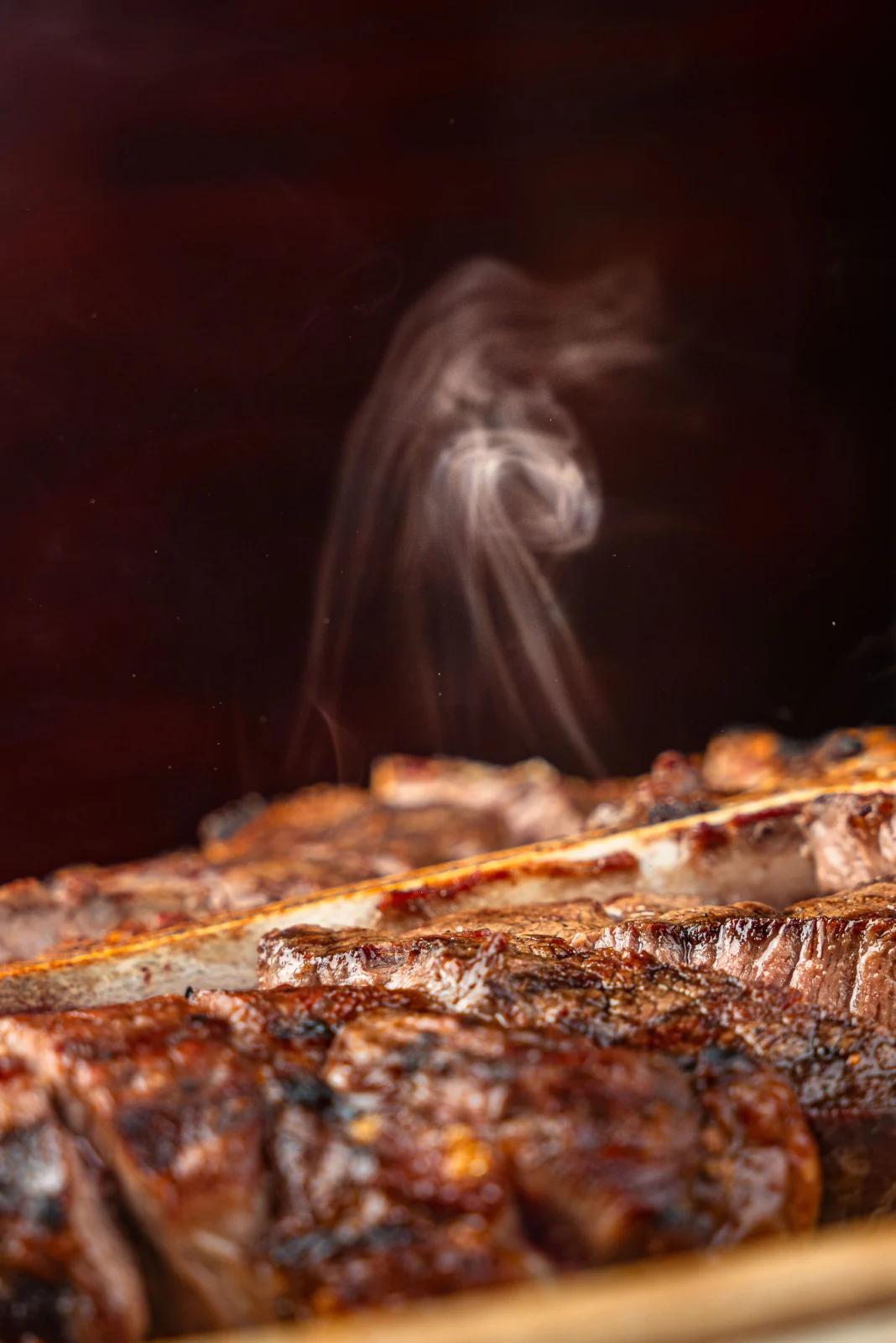 Grilled steak with rising smoke